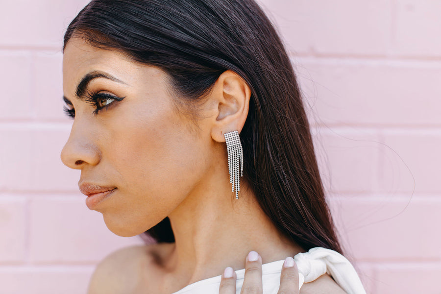 Brunette woman looking into the distance, wearing our Equinox earrings.